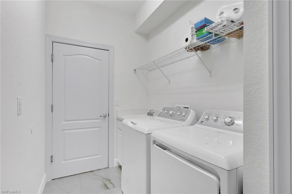 2045 Mandarin Lane Naples, FL 34120 - Photo 27 of 34 a utility room with dryer and washer