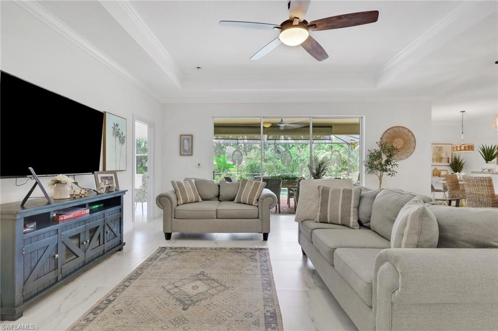 2045 Mandarin Lane Naples, FL 34120 - Photo 8 of 34 a living room with furniture and a flat screen tv