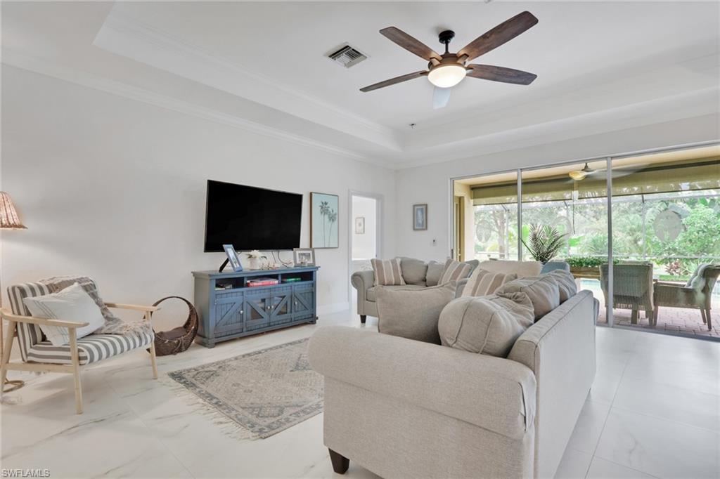 2045 Mandarin Lane Naples, FL 34120 - Photo 9 of 34 a living room with furniture and a flat screen tv