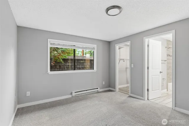 an empty room with windows and closet