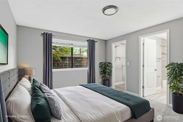 a bedroom with a bed and a large window