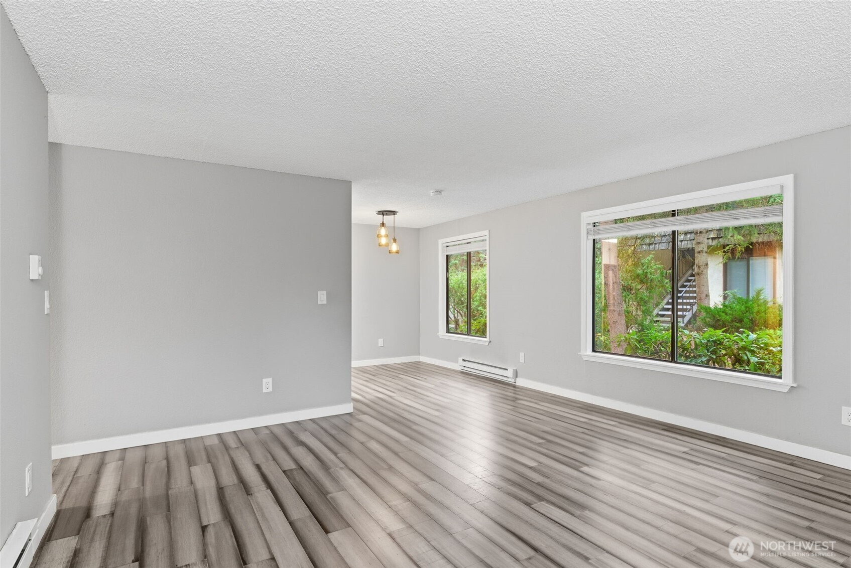 8621 25th Avenue Southwest, Unit B Seattle, WA 98106 - Photo 6 of 33 a view of an empty room with window and wooden floor