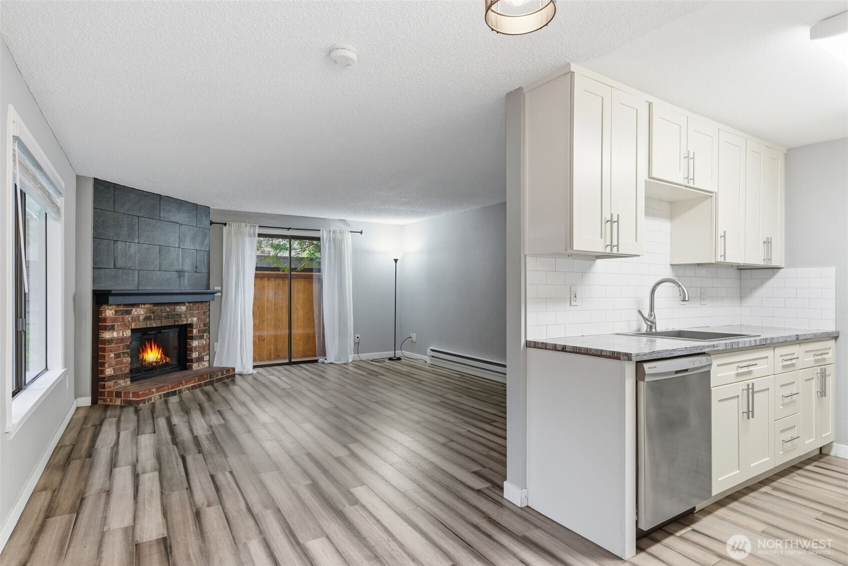 8621 25th Avenue Southwest, Unit B Seattle, WA 98106 - Photo 8 of 33 a kitchen with a sink and wooden floor