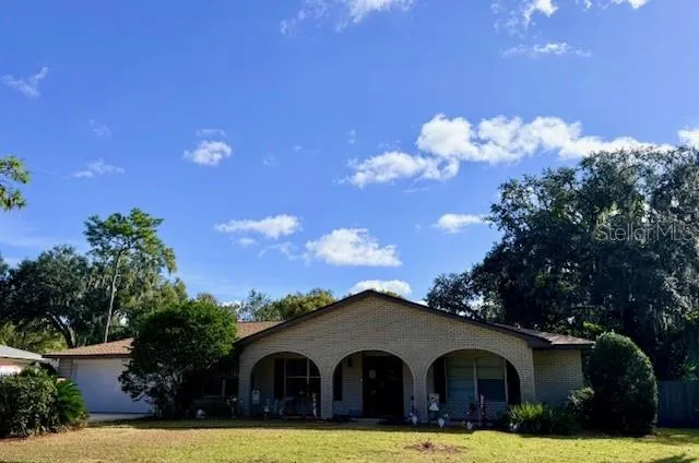 a front view of house with yard and trees