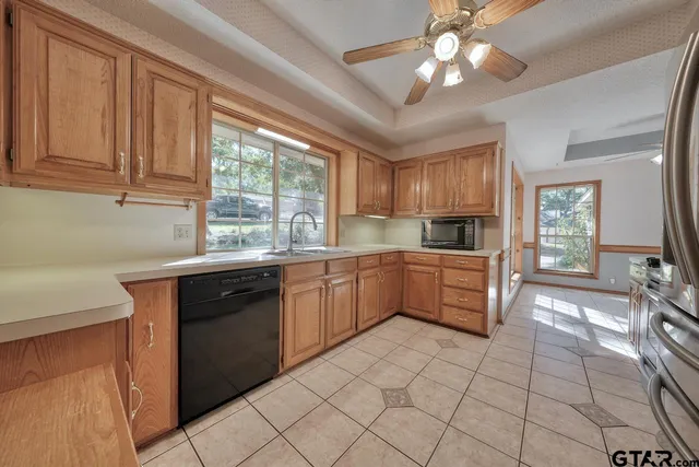 a kitchen with a sink and large window