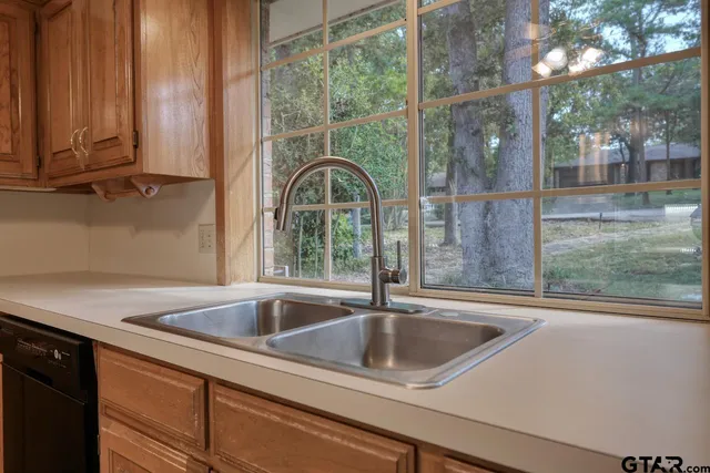 a kitchen with granite countertop cabinets stainless steel appliances and a counter space
