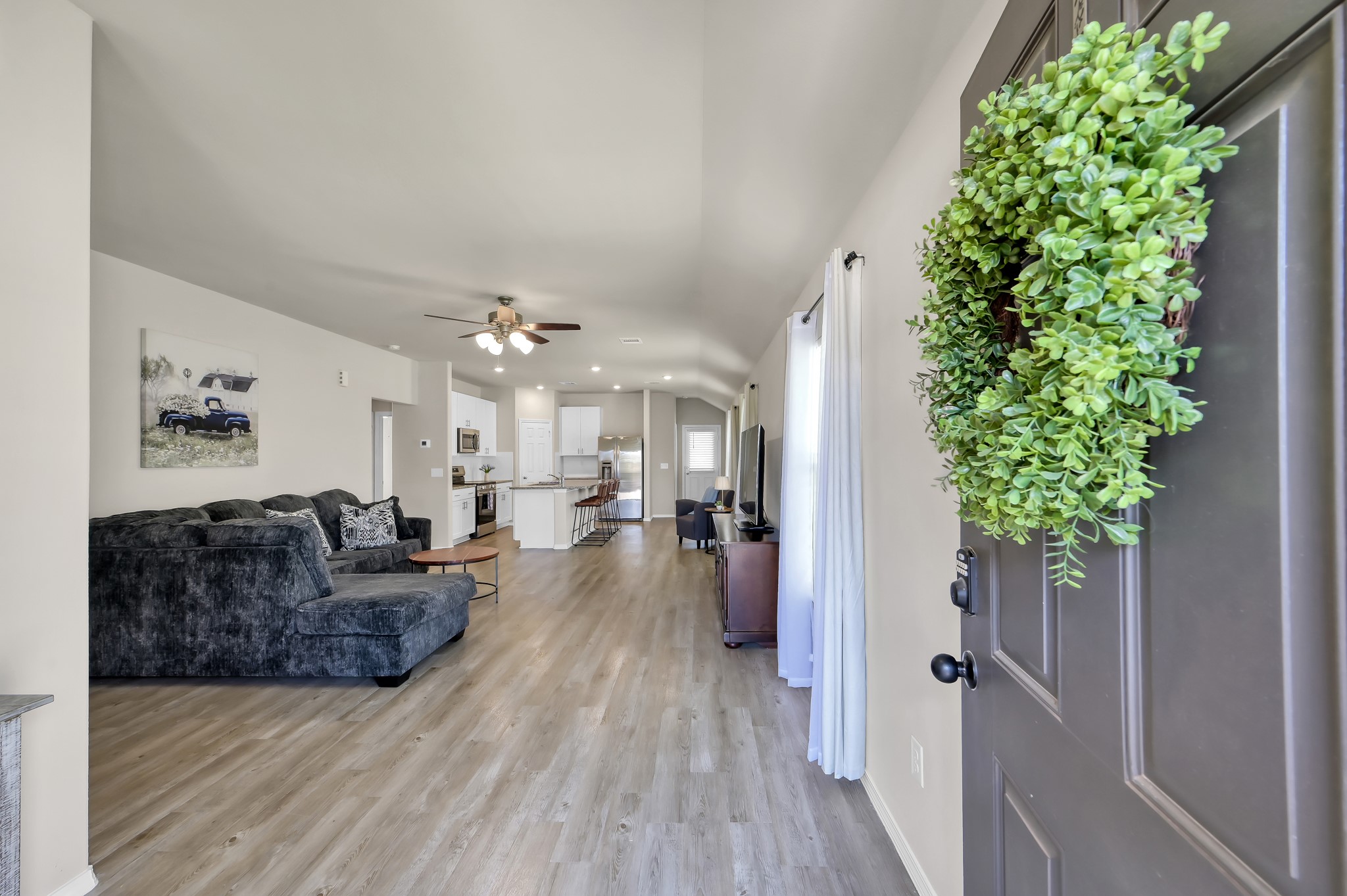 514 Dalloway Street Conroe, TX 77316 - Photo 6 of 27 Entry view into open-concept living space with natural light and modern flooring