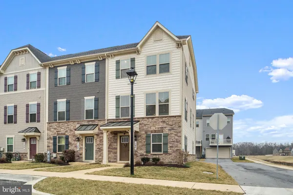 a front view of a residential apartment building with a yard