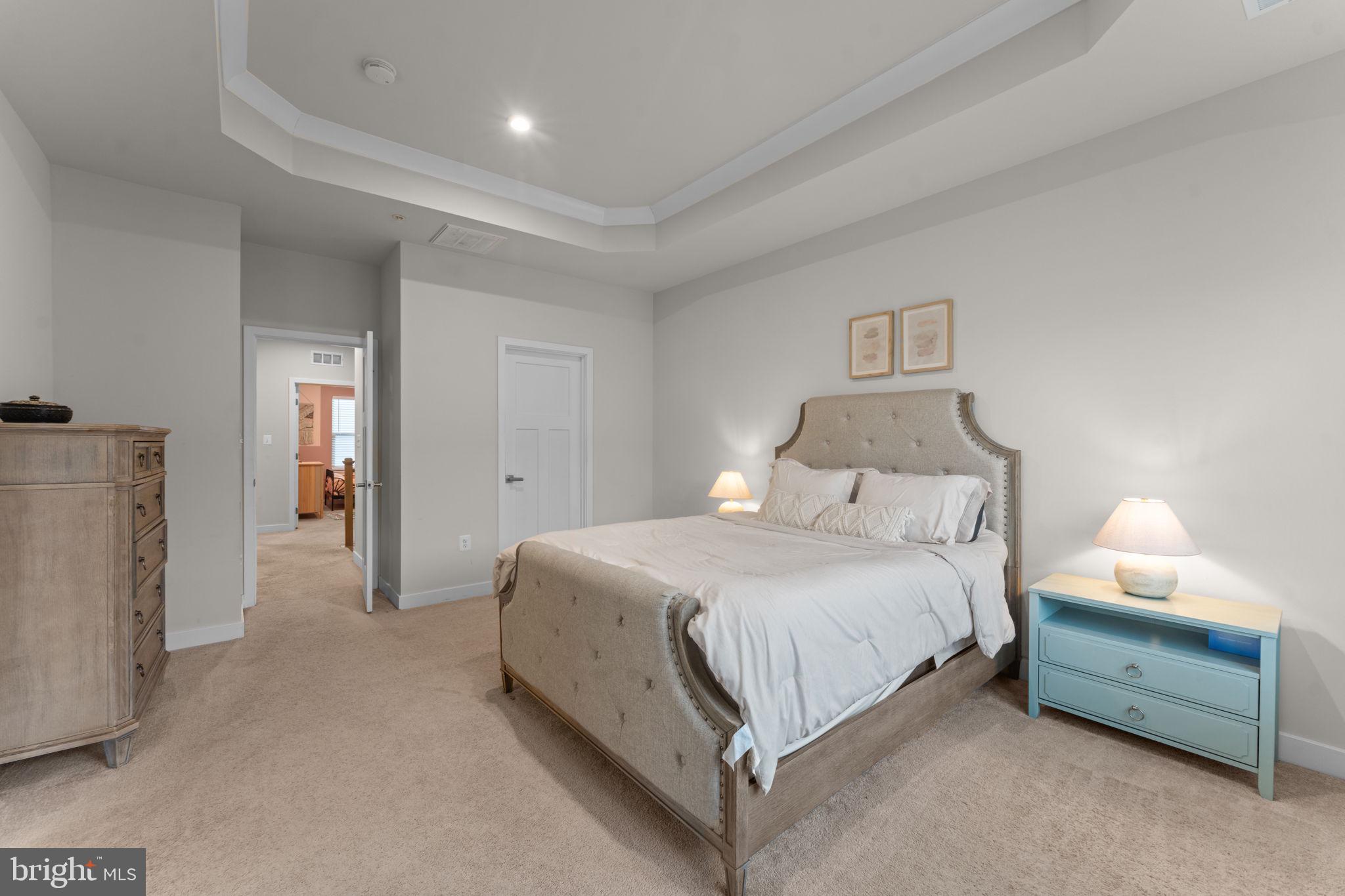 160 Lyons Creek Drive Laurel, MD 20708 - Photo 40 of 88 a spacious bedroom with a bed and a lamp