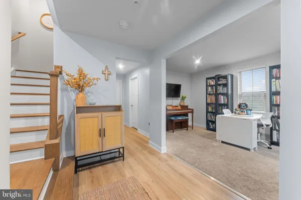 a view of a workspace with furniture and a window