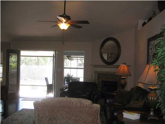 174 East Shipwreck Road Santa Rosa Beach, FL 32459 - Photo 2 of 11 a living room with furniture a fireplace and a large window