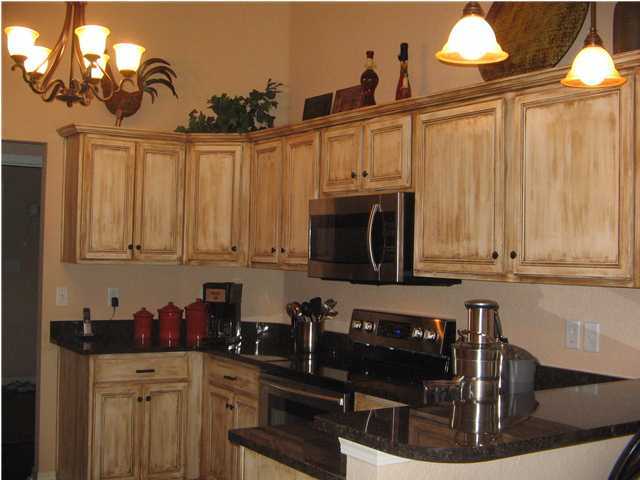 174 East Shipwreck Road Santa Rosa Beach, FL 32459 - Photo 4 of 11 a kitchen with stainless steel appliances granite countertop a sink dishwasher a stove a microwave and cabinets