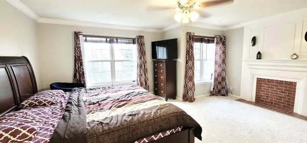 a bedroom with a bed and a fireplace