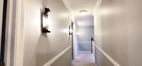 a view of hallway with shower and wooden floor