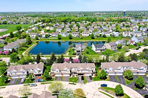 an aerial view of residential houses with outdoor space
