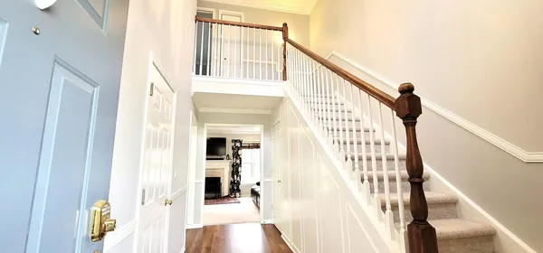a view of entryway and hall with wooden floor