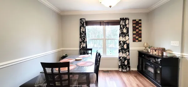 a view of a dining room with furniture and wooden floor