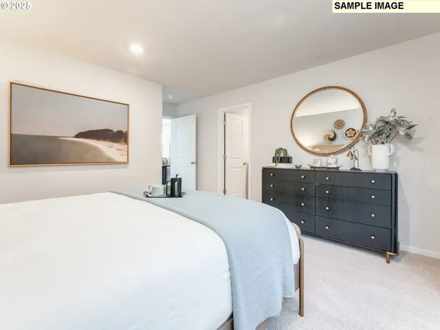 a bedroom with a bed and a painting on the wall