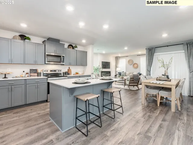 a kitchen with a sink cabinets and wooden floor
