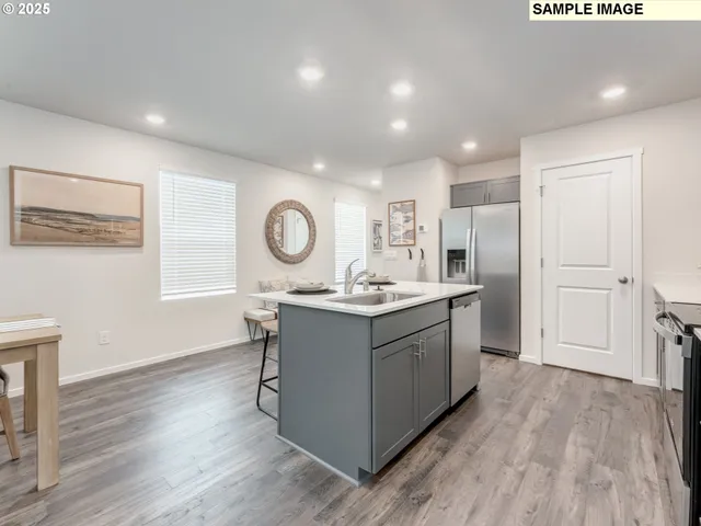 a kitchen with sink cabinets and wooden floor