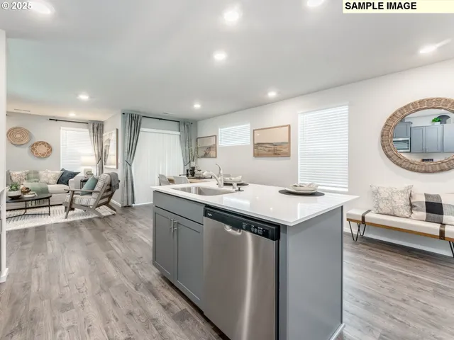 a kitchen with stainless steel appliances granite countertop a sink stove and wooden floor