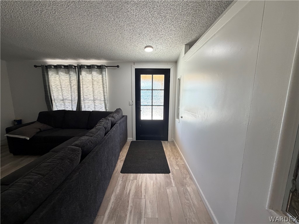 1910 Rio Grande Road Bullhead City, AZ 86442 - Photo 7 of 29 Entryway featuring a black paneled door with glass inserts, wood-finish flooring, and a recessed ceiling light