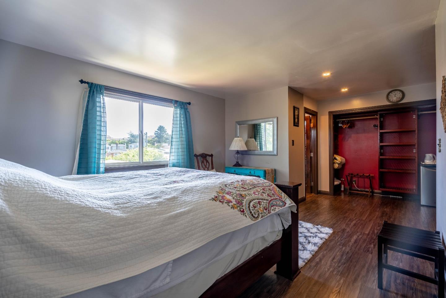 348 Heathcliff Drive Pacifica, CA 94044 - Photo 14 of 37 a bedroom with a large bed and wooden floor