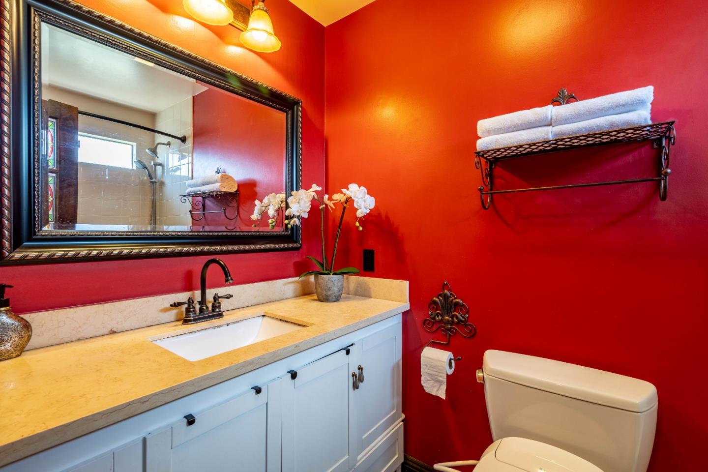 348 Heathcliff Drive Pacifica, CA 94044 - Photo 15 of 37 a bathroom with a toilet sink and mirror