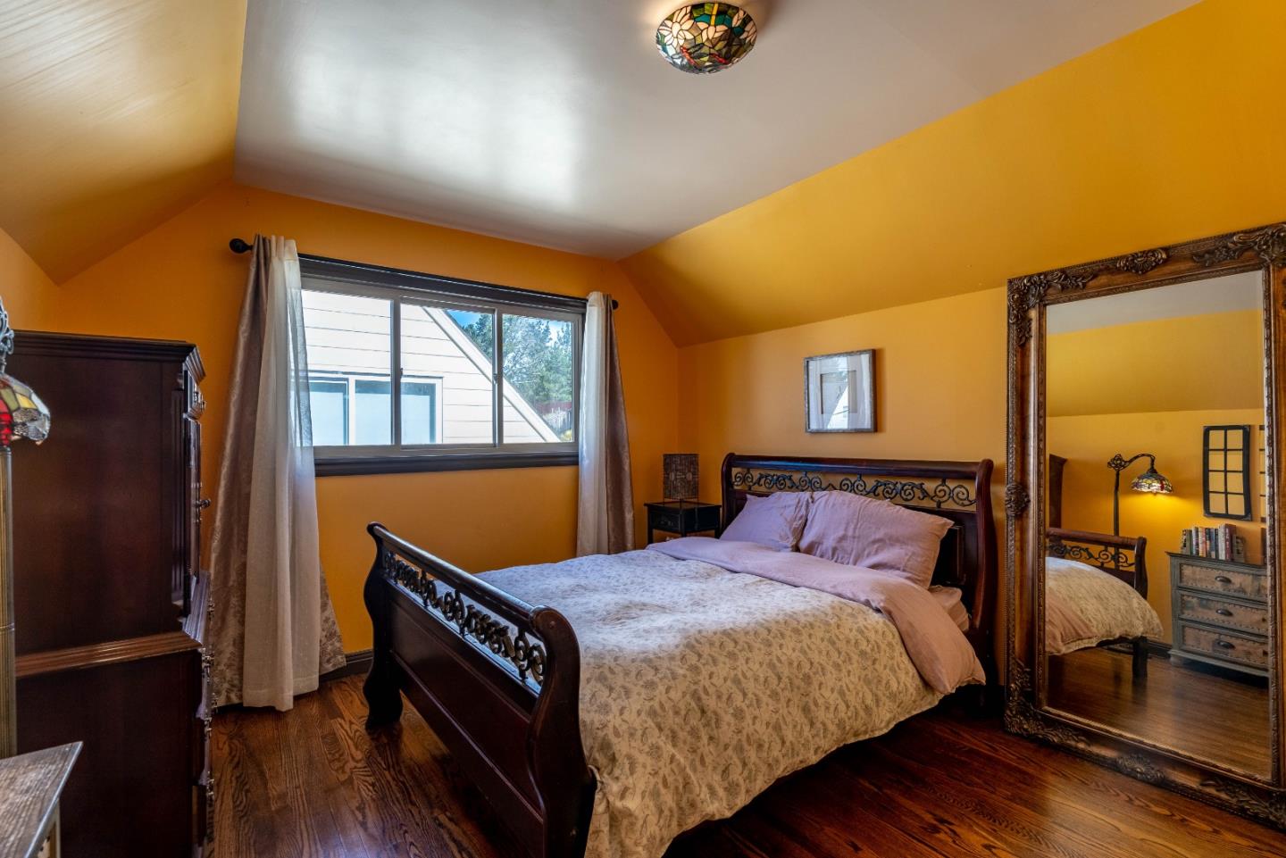 348 Heathcliff Drive Pacifica, CA 94044 - Photo 17 of 37 a bedroom with a bed a dresser next to a window