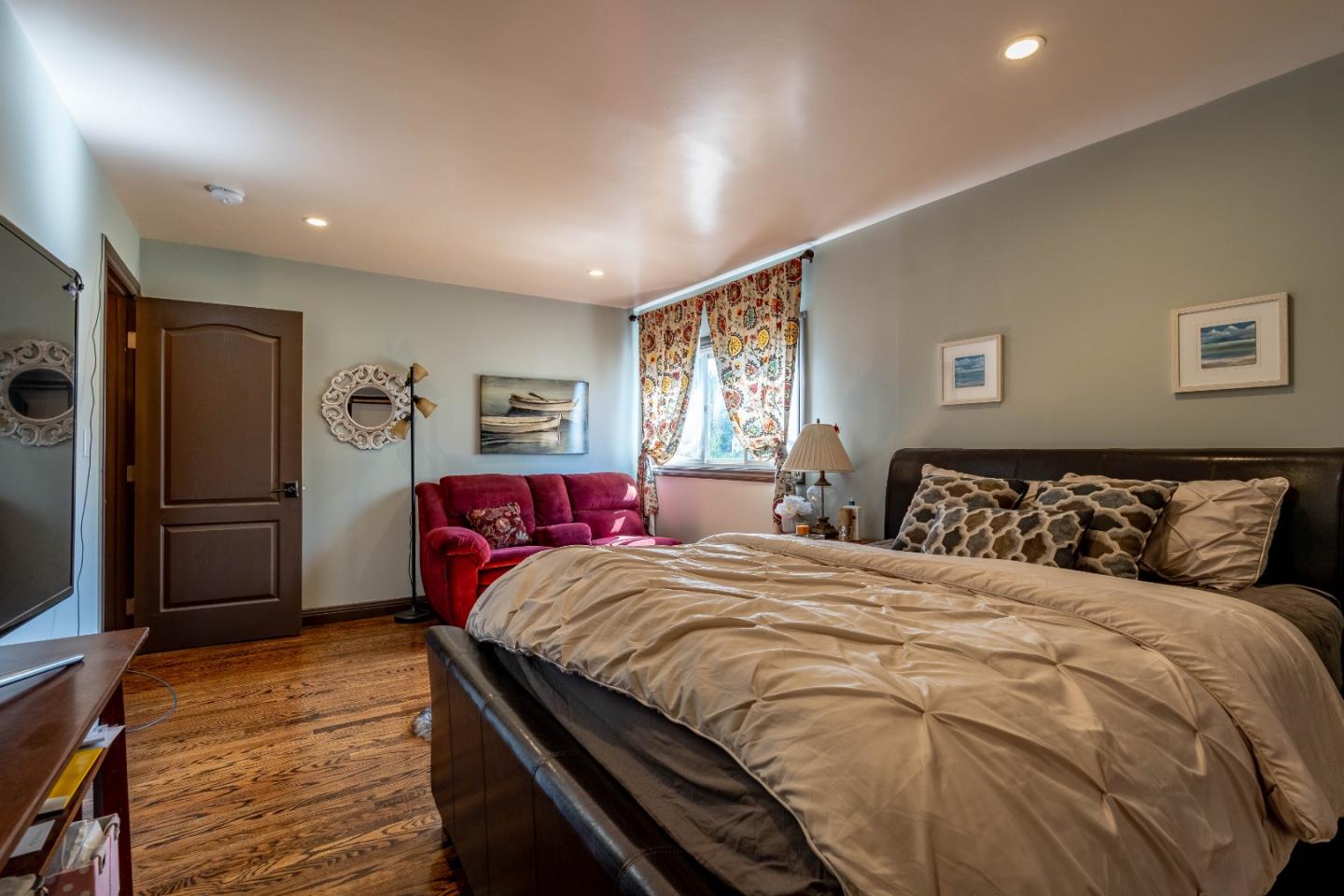 348 Heathcliff Drive Pacifica, CA 94044 - Photo 18 of 37 a bedroom with double bed and a refrigerator