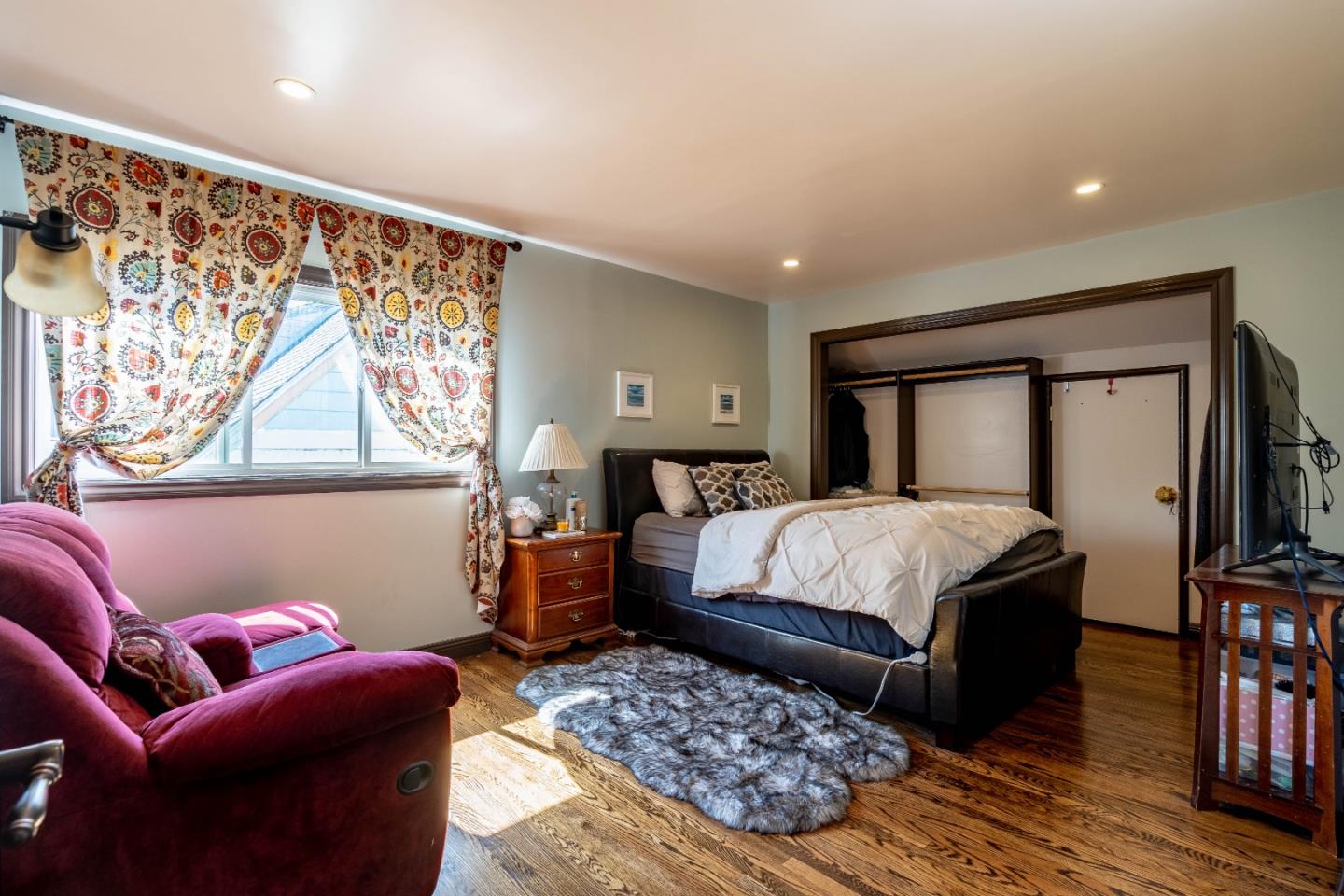 348 Heathcliff Drive Pacifica, CA 94044 - Photo 19 of 37 a bedroom with a large bed and a couch