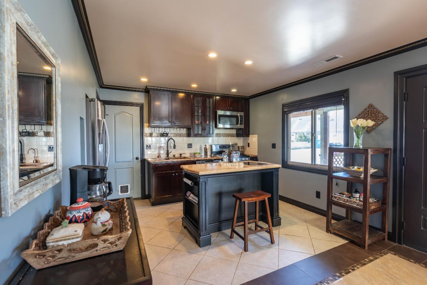 348 Heathcliff Drive Pacifica, CA 94044 - Photo 6 of 37 a kitchen with a refrigerator and a dining table
