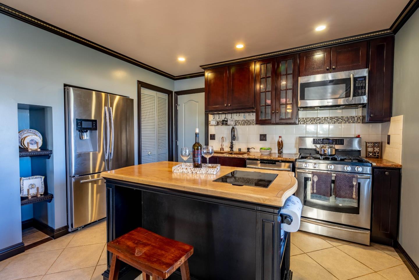 348 Heathcliff Drive Pacifica, CA 94044 - Photo 7 of 37 a kitchen with stainless steel appliances granite countertop a refrigerator stove top oven and sink