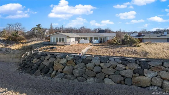 a view of a dry yard with wooden fence