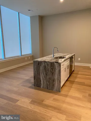 a kitchen with stainless steel appliances granite countertop a sink and a stove