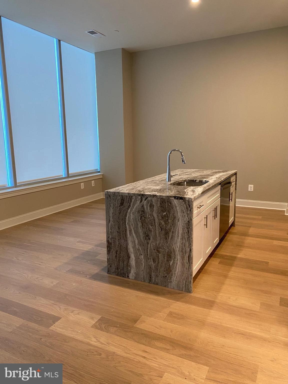 a kitchen with stainless steel appliances granite countertop a sink and a stove