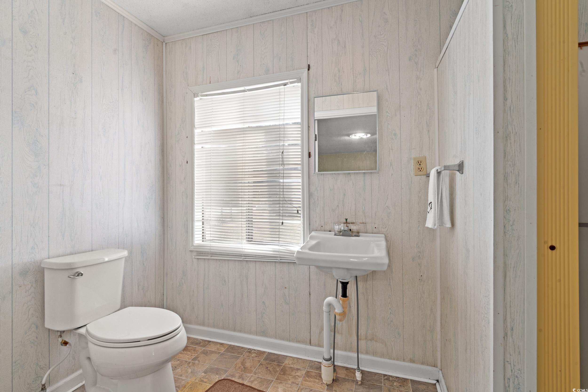 4422 Grady Road Mullins, SC 29574 - Photo 21 of 28 Bathroom with ornamental molding and wood walls