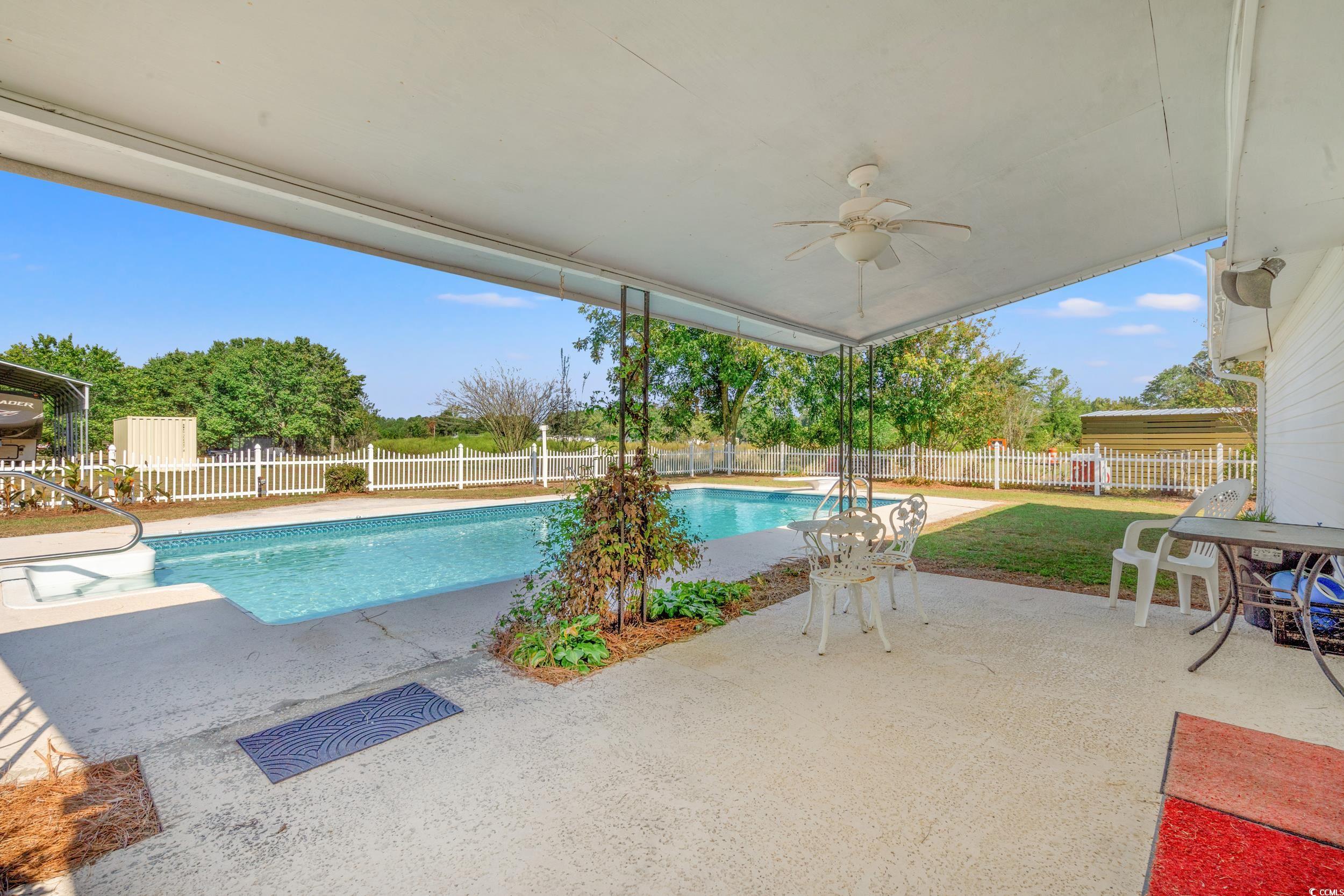 4422 Grady Road Mullins, SC 29574 - Photo 22 of 28 View of pool featuring a patio, a ceiling fan, and a fenced backyard