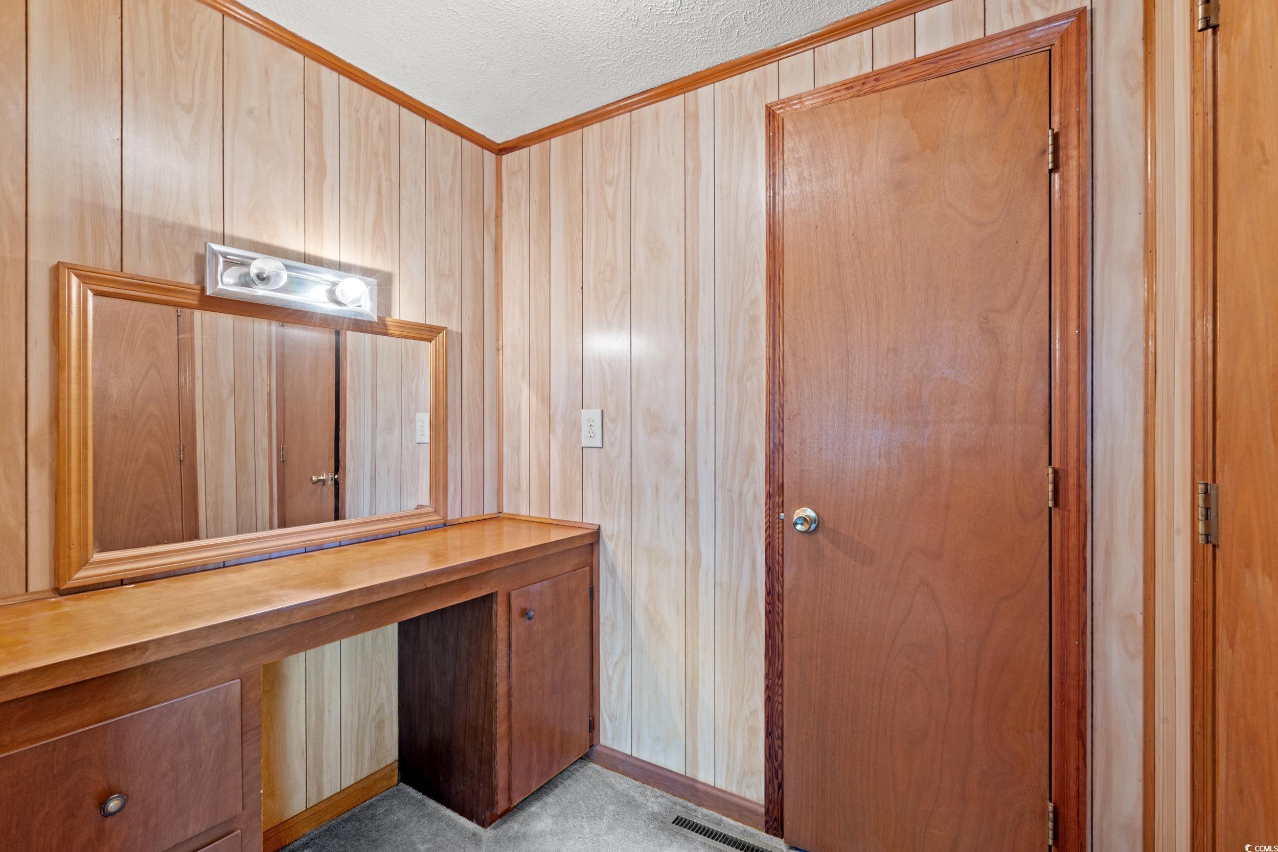4422 Grady Road Mullins, SC 29574 - Photo 10 of 28 Unfurnished office with wood walls, a textured ceiling, ornamental molding, and light carpet