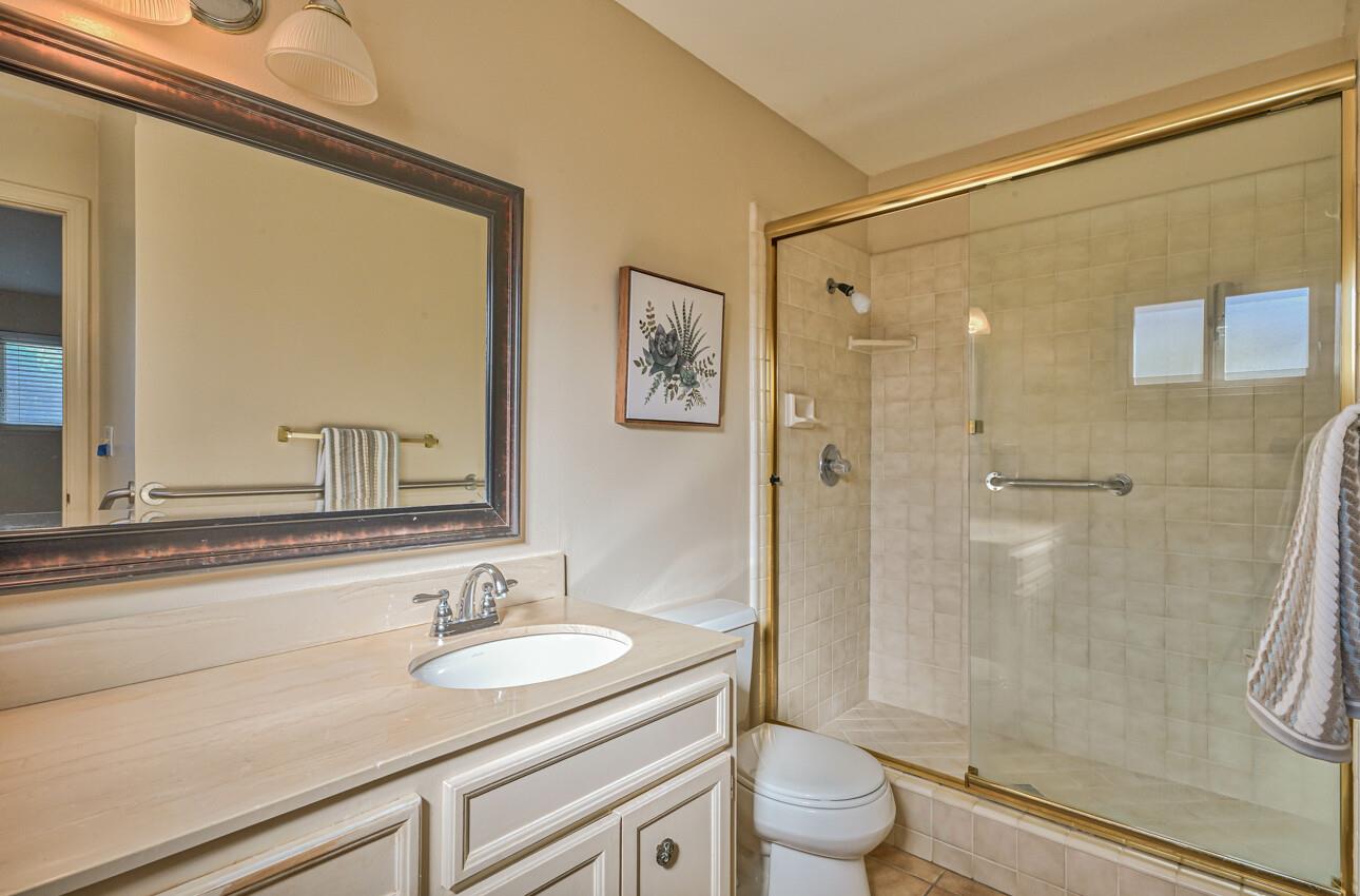 561 Palma Drive Salinas, CA 93901 - Photo 17 of 25 a bathroom with a granite countertop sink a toilet and shower
