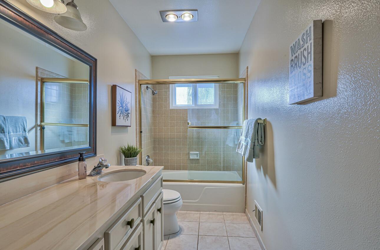 561 Palma Drive Salinas, CA 93901 - Photo 22 of 25 a bathroom with a granite countertop sink and a mirror