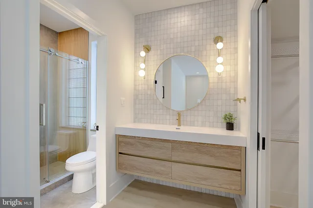 a bathroom with a toilet sink and mirror