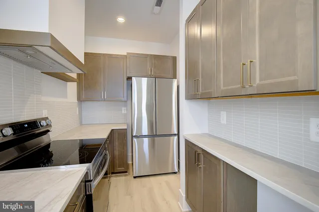 a kitchen with a refrigerator and a sink