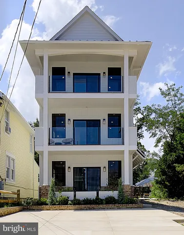 a front view of a house with plants
