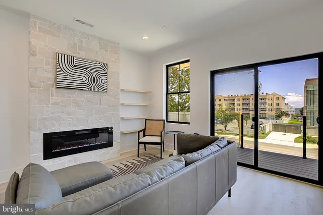a living room with furniture and a floor to ceiling window