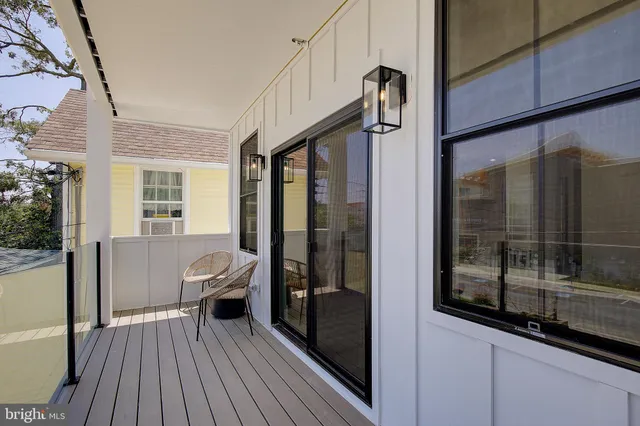 a balcony view with a couch and wooden floor