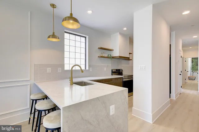 a kitchen with a sink cabinets and window