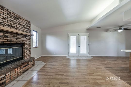 407 South Sunland Street Ridgecrest, CA 93555 - Photo 8 of 28 a view of an empty room with window and fireplace