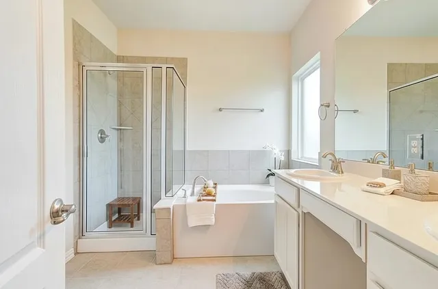 a bathroom with a tub sink and mirror