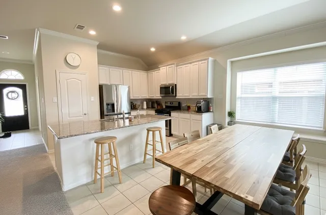a large kitchen with lots of counter space and window